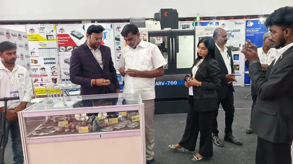 Two exhibitors discussing products across a display counter