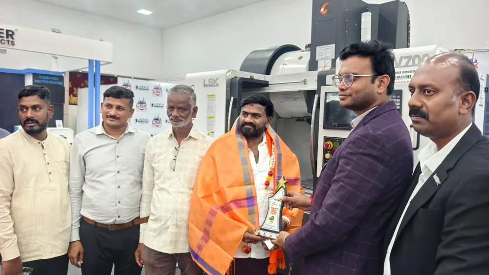 Group of exhibitors and buyers gathered around machinery